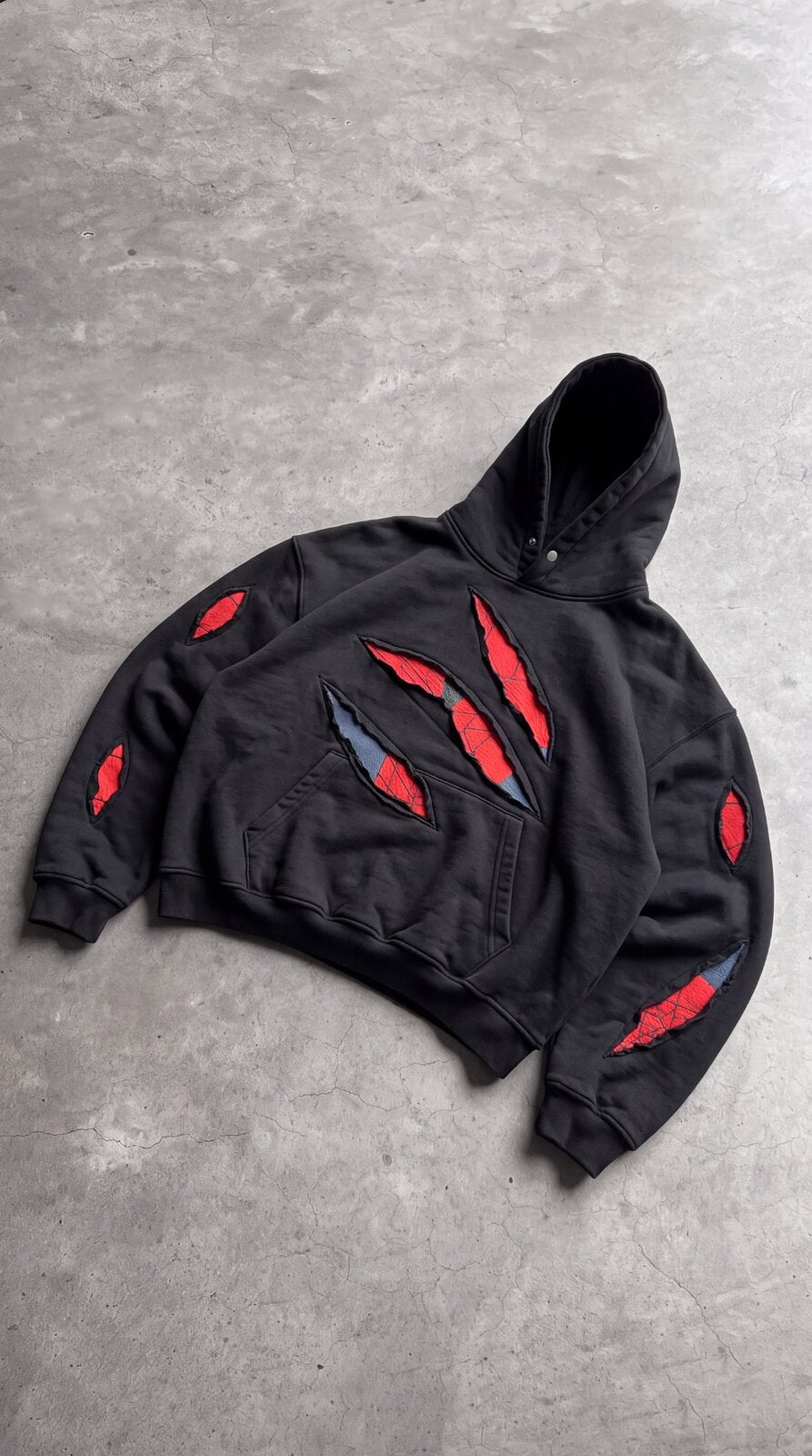 SpideyComfort distressed spider-web hoodie flat lay