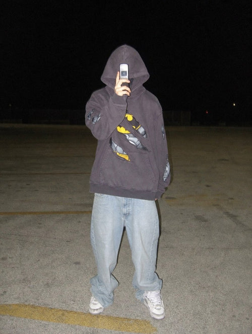 Nightfall Hoodie worn oversized in a parking lot at night