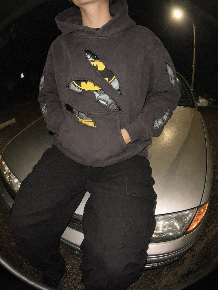 Nightfall Hoodie worn sitting on a car hood