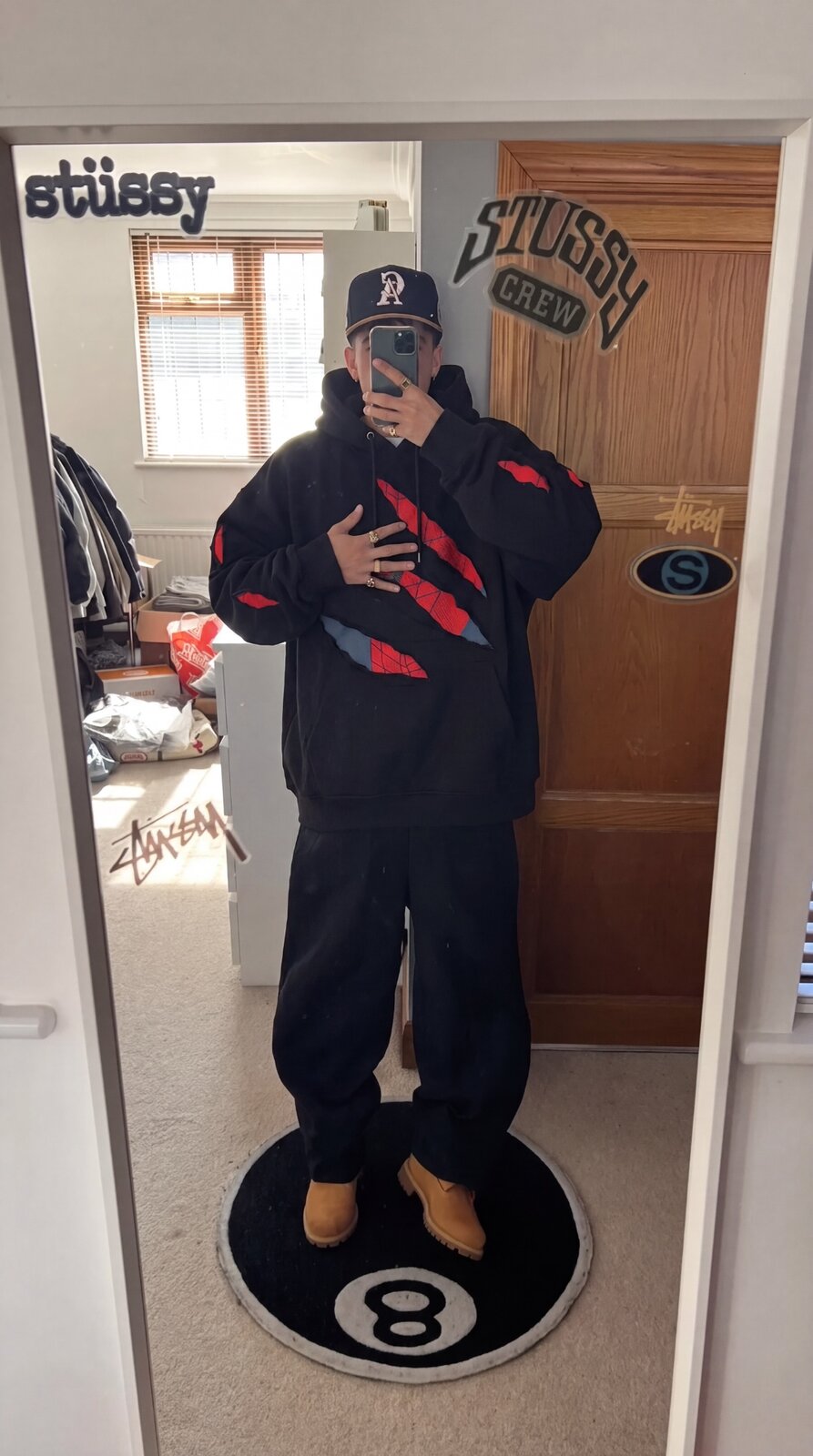 SpideyComfort distressed spider-web hoodie worn in a retail store