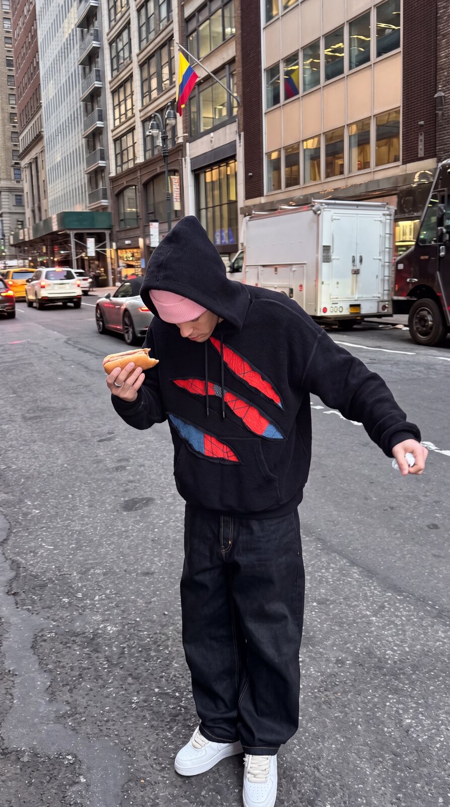SpideyComfort distressed spider-web hoodie worn on a NYC street
